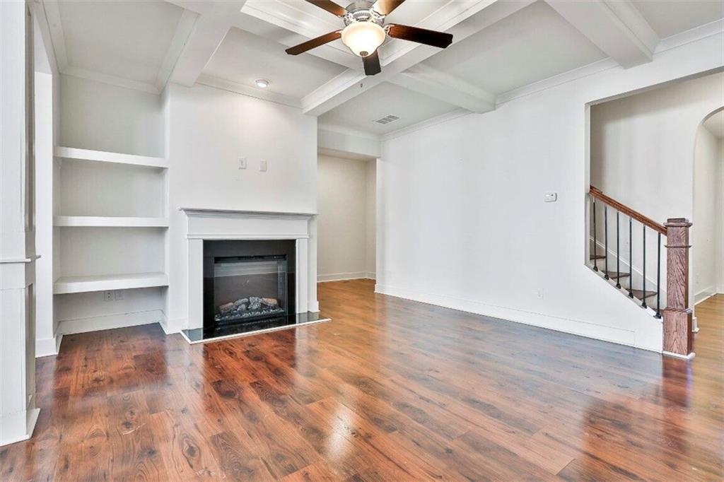 7641 Squire Court Fairburn, GA 30213 - Photo 8 of 33 a view of an empty room with a fireplace and a window