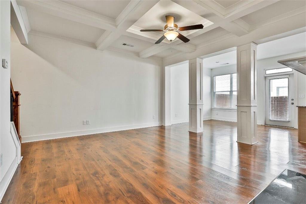 7641 Squire Court Fairburn, GA 30213 - Photo 9 of 33 wooden floor in an empty room with a window