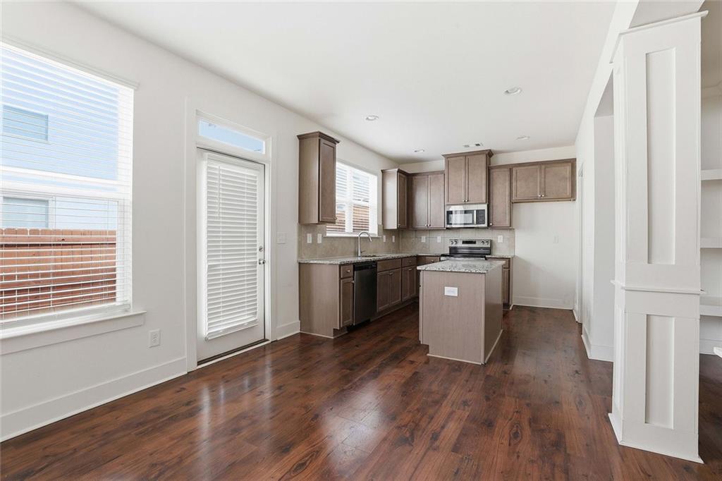 7641 Squire Court Fairburn, GA 30213 - Photo 10 of 33 a kitchen with a white cabinets and wooden floor