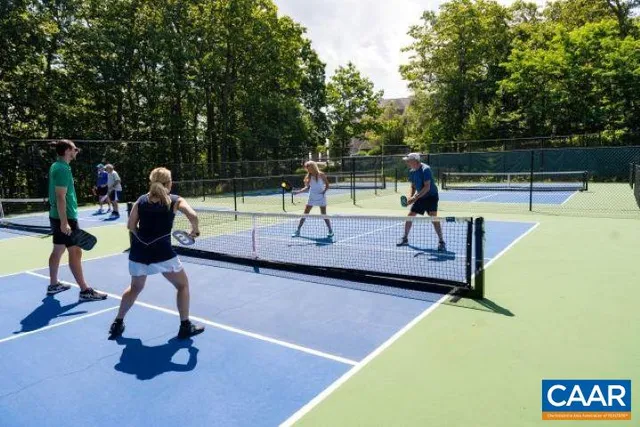 a aerial view of a house with swimming pool patio and outdoor seating