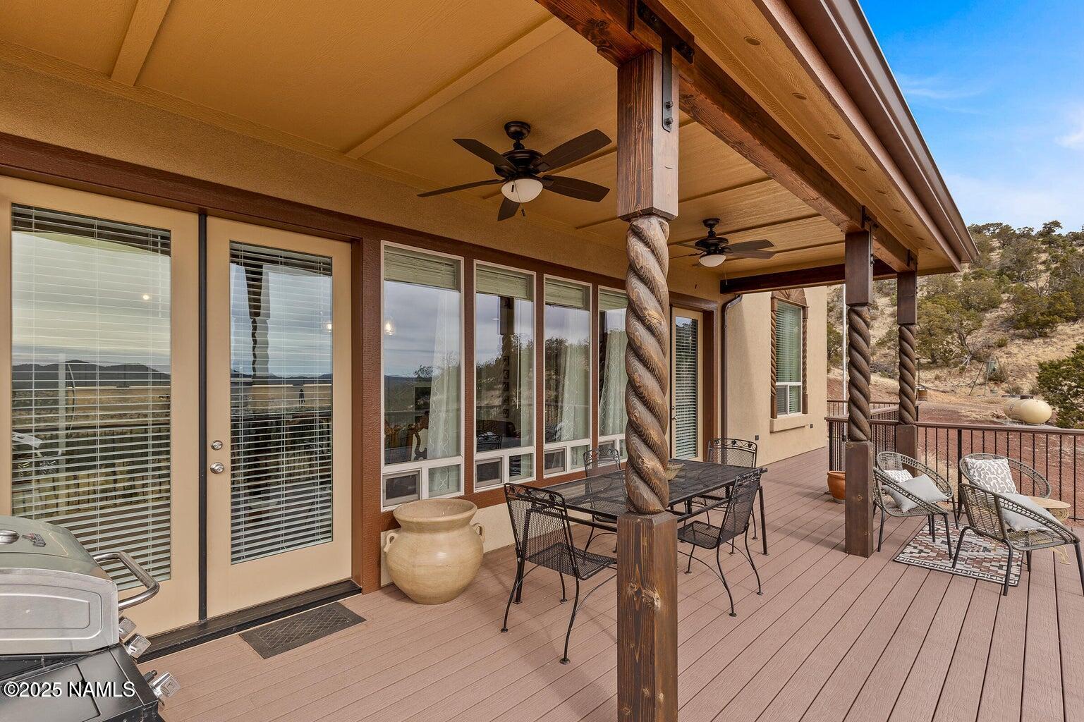 a view of a patio with table and chairs and wooden floor