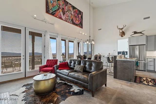 a living room with furniture and a floor to ceiling window