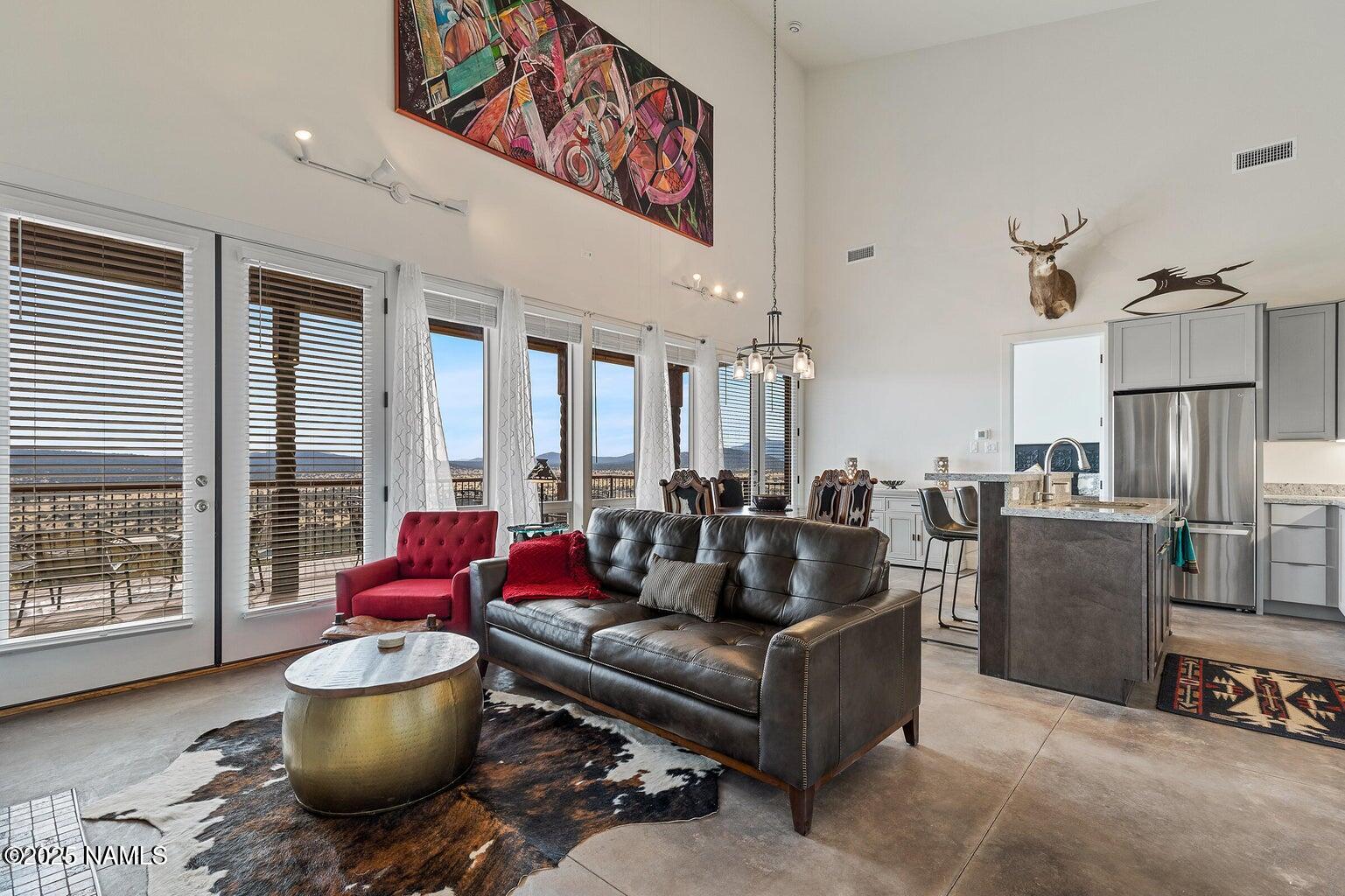 1843 East Sagebrush Road Williams, AZ 86046 - Photo 4 of 31 a living room with furniture and a floor to ceiling window