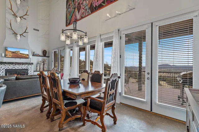 a dining room with furniture a chandelier and window