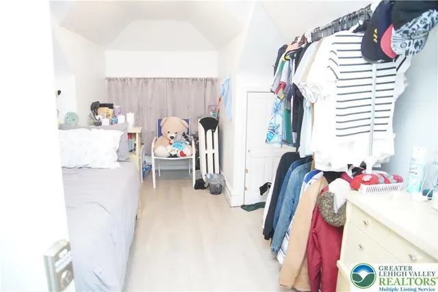 a bedroom with a bed and a shower