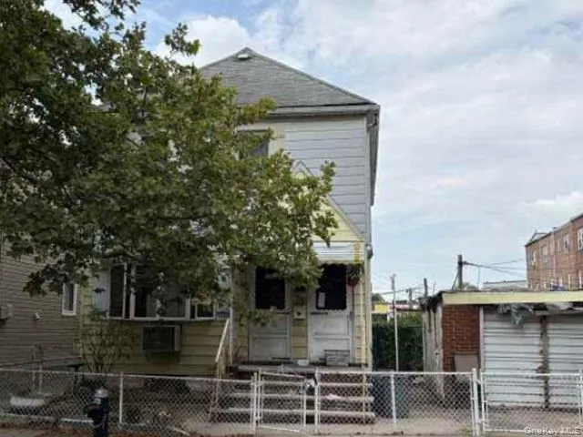 a front view of a house with plants