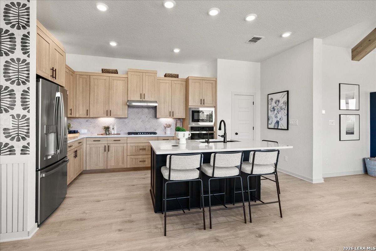 2126 Shepards Street Seguin, TX 78155 - Photo 5 of 20 a kitchen with a table chairs refrigerator and cabinets