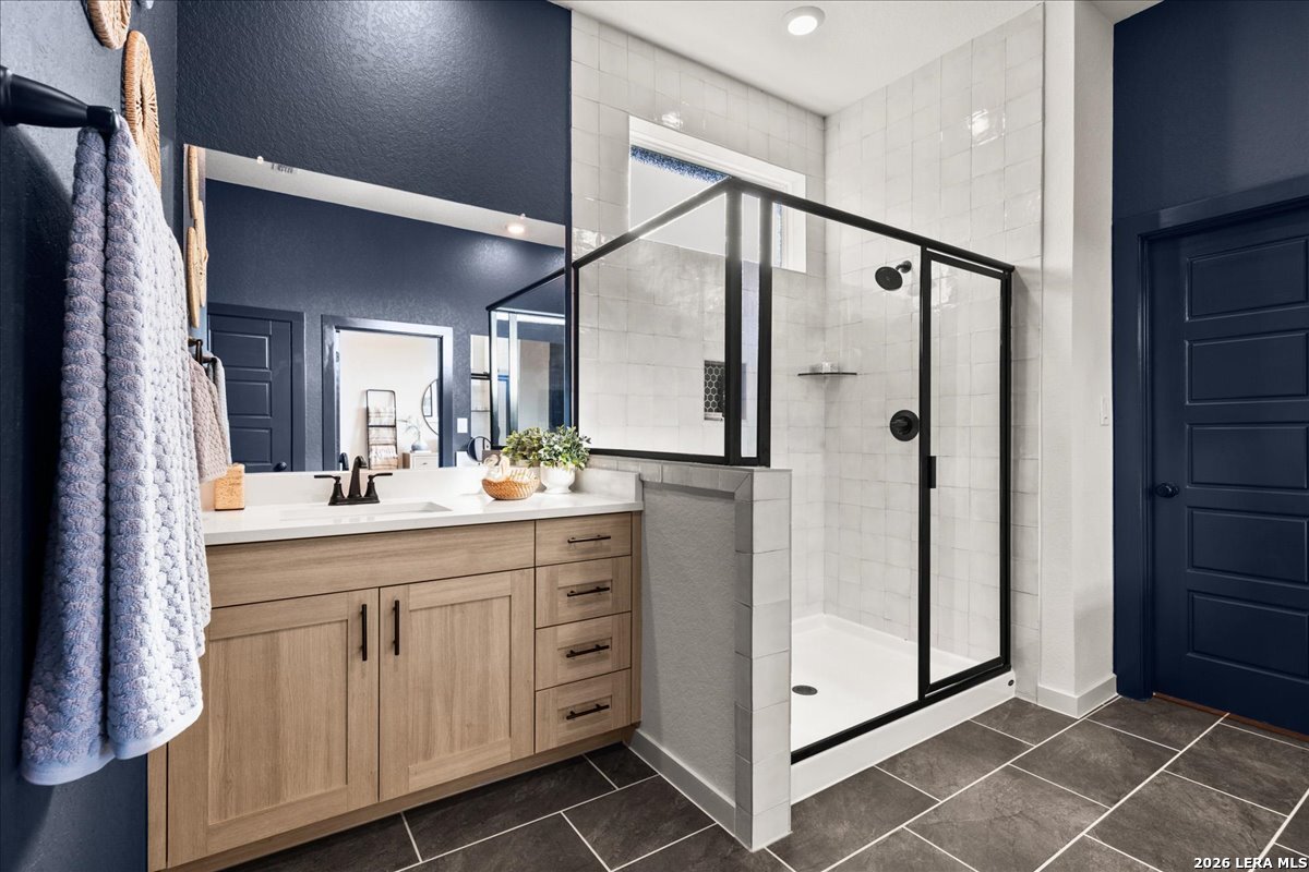 2126 Shepards Street Seguin, TX 78155 - Photo 10 of 20 a bathroom with a double vanity sink mirror and shower