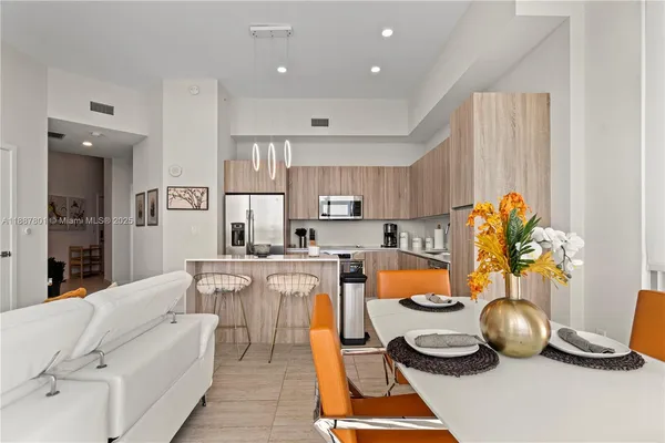 a large kitchen with a table and chairs