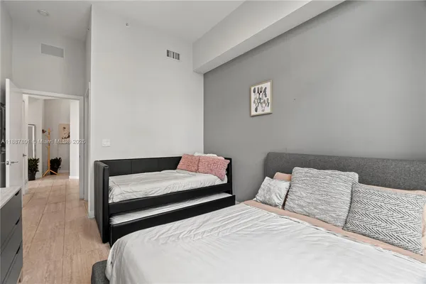 a bedroom with two beds and a table