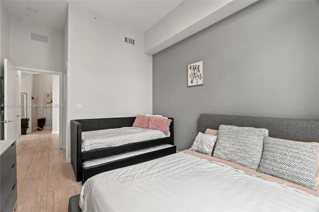 a bedroom with two beds and a table