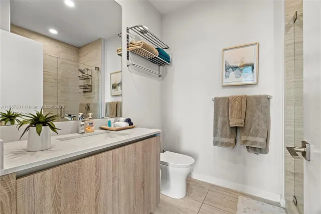 a bathroom with a sink a toilet and mirror