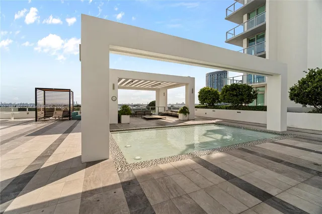 a view of a swimming pool with a patio