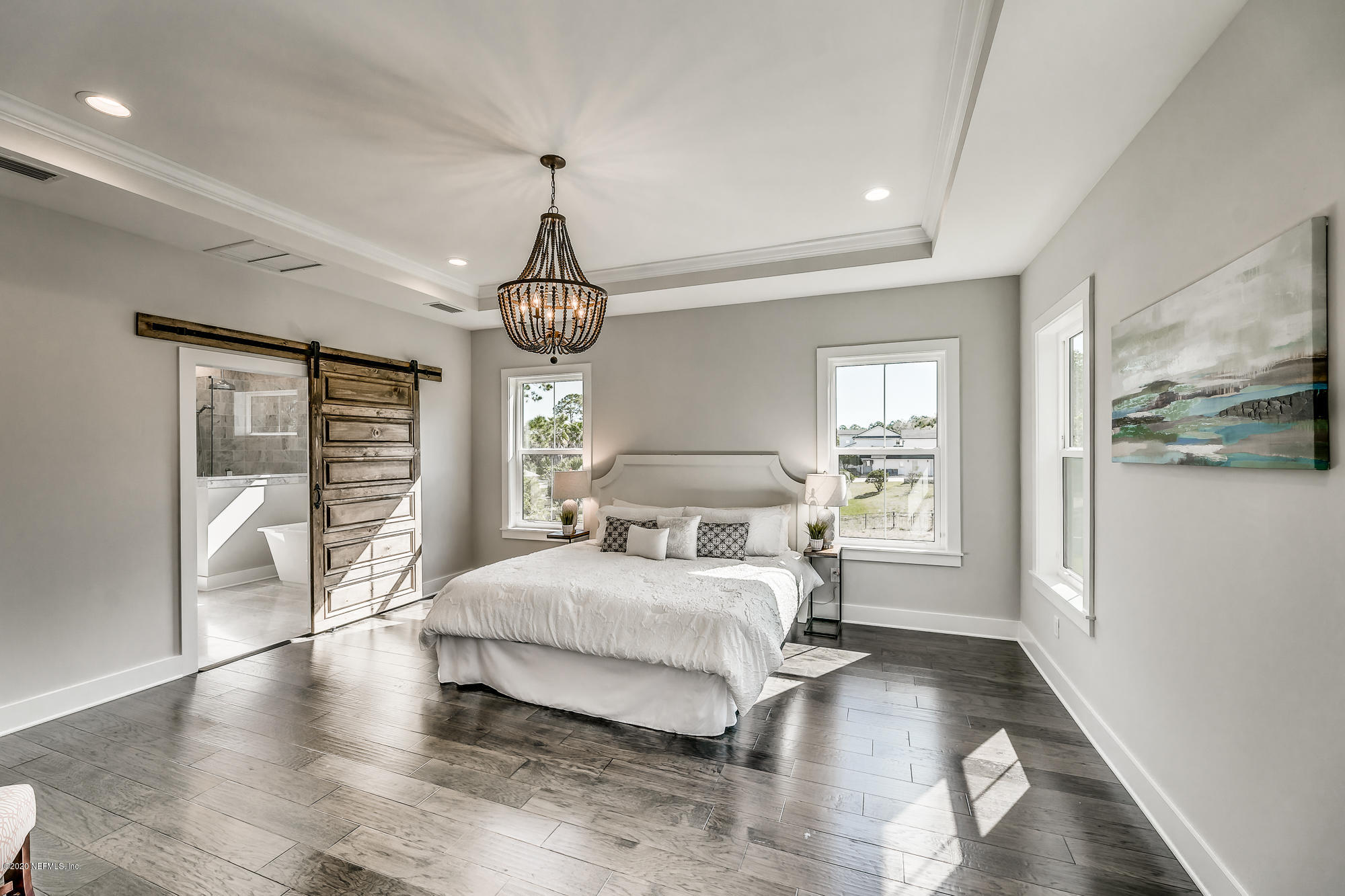 12507 Hidden Drive Jacksonville, FL 32225 - Photo 45 of 66 a bedroom with a large bed and a large window