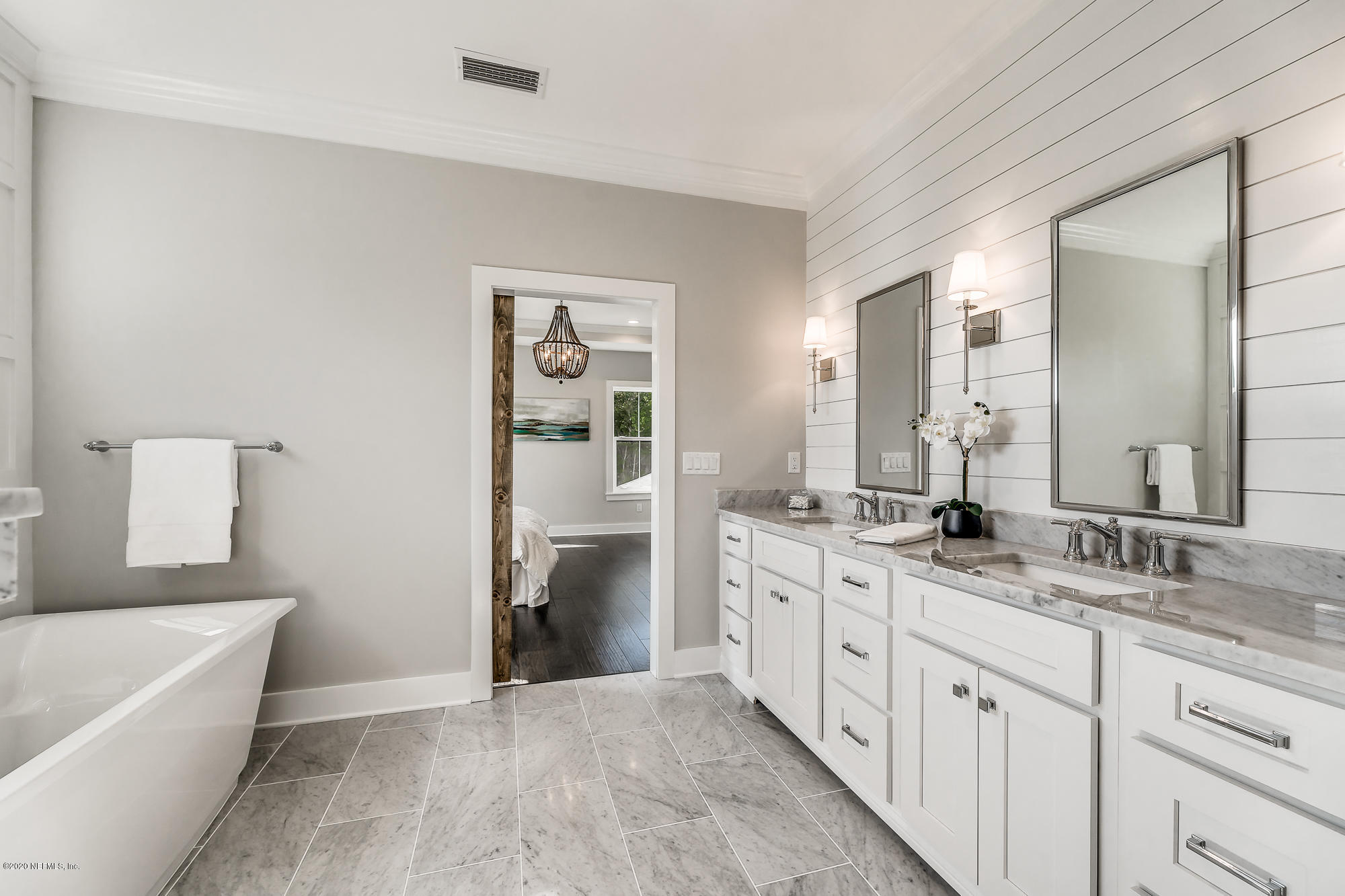 12507 Hidden Drive Jacksonville, FL 32225 - Photo 52 of 66 a spacious bathroom with a granite countertop double vanity sink a mirror and a bathtub