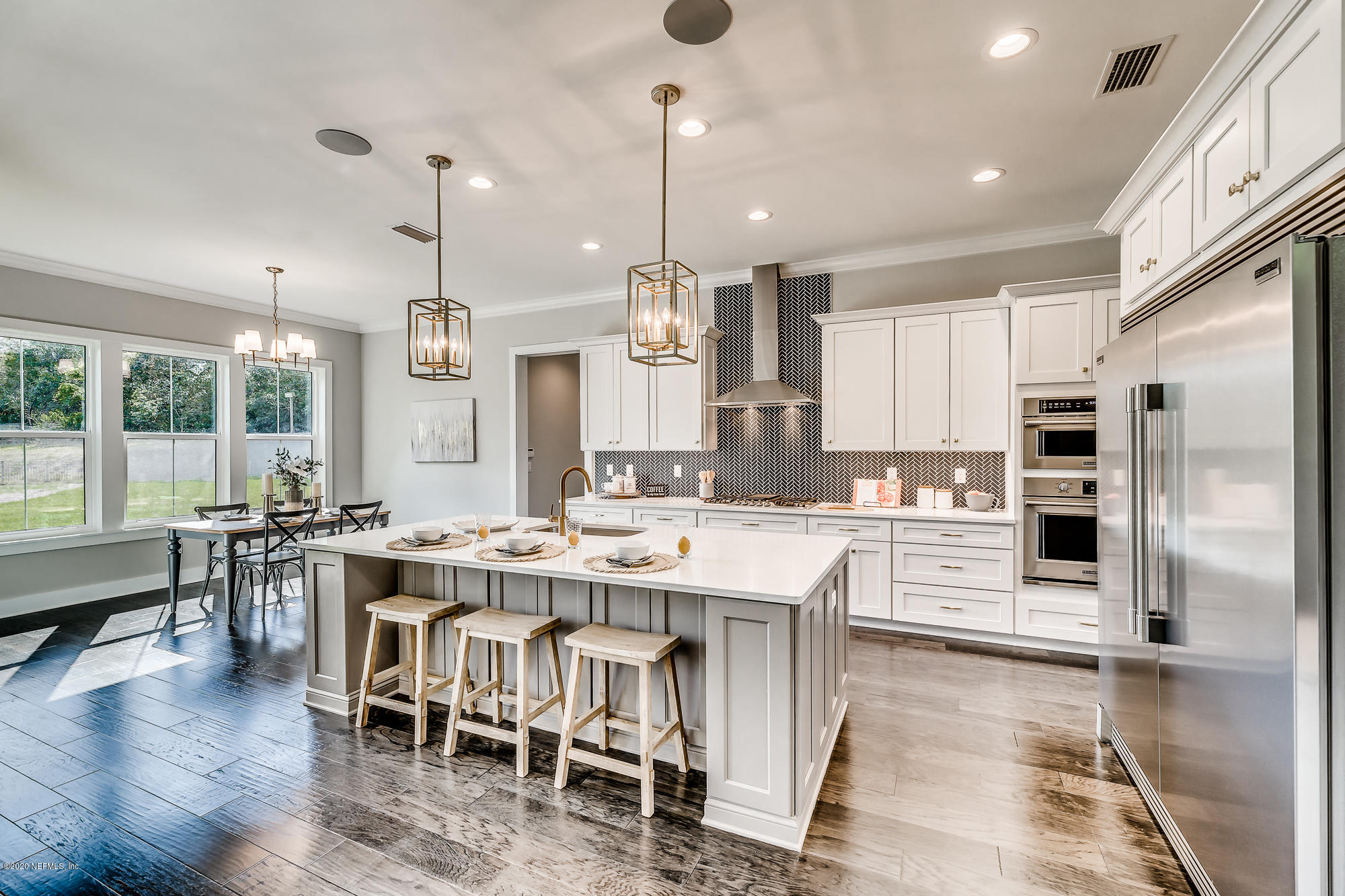 12507 Hidden Drive Jacksonville, FL 32225 - Photo 8 of 66 a kitchen with stainless steel appliances kitchen island granite countertop a table chairs stove and refrigerator