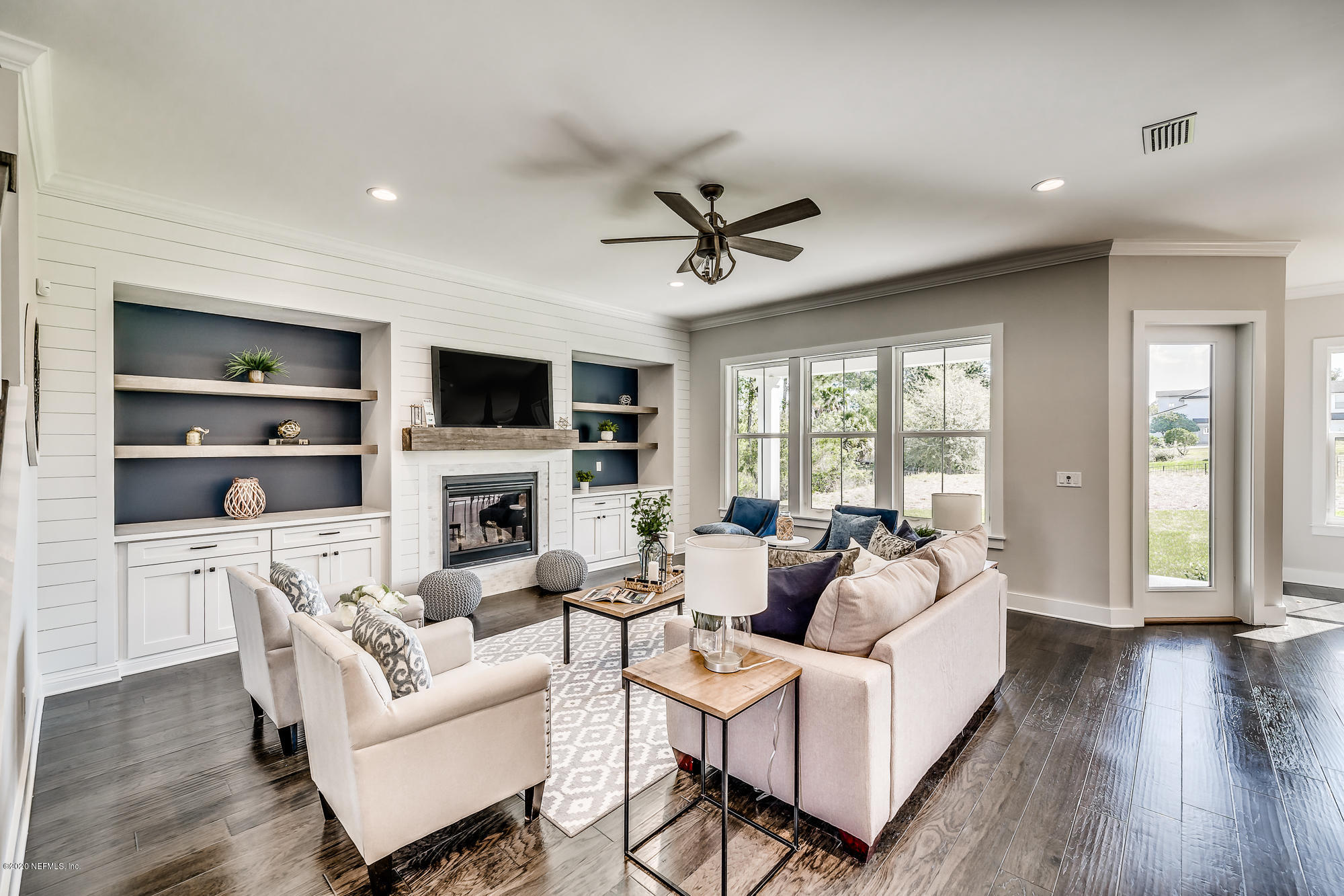 12507 Hidden Drive Jacksonville, FL 32225 - Photo 9 of 66 a living room with furniture a fireplace and a flat screen tv