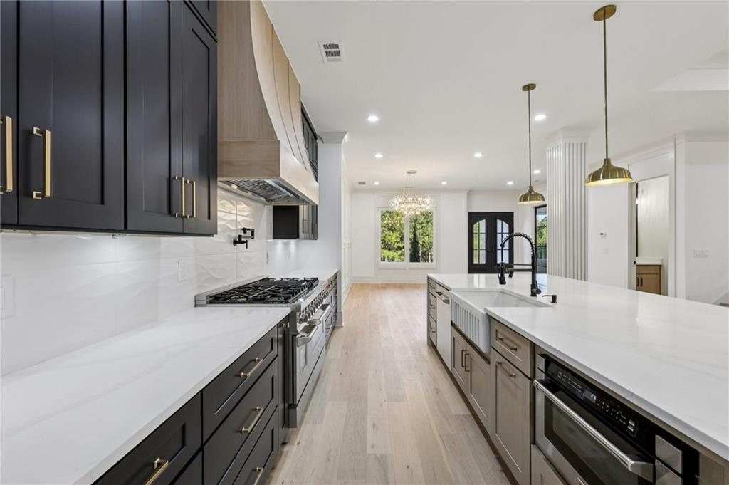 3209 Bold Springs Road Dacula, GA 30019 - Photo 15 of 62 a large kitchen with stainless steel appliances granite countertop a lot of counter space and a sink