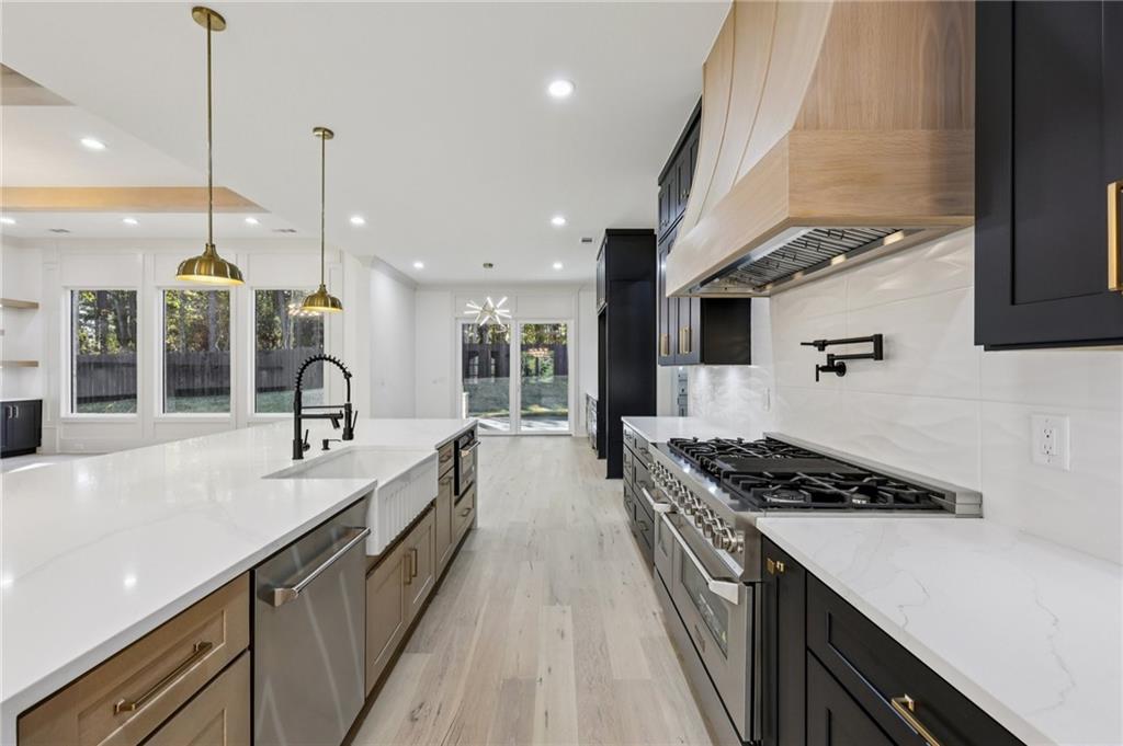 3209 Bold Springs Road Dacula, GA 30019 - Photo 19 of 62 a kitchen with kitchen island stainless steel appliances a sink a counter top space a stove and a window