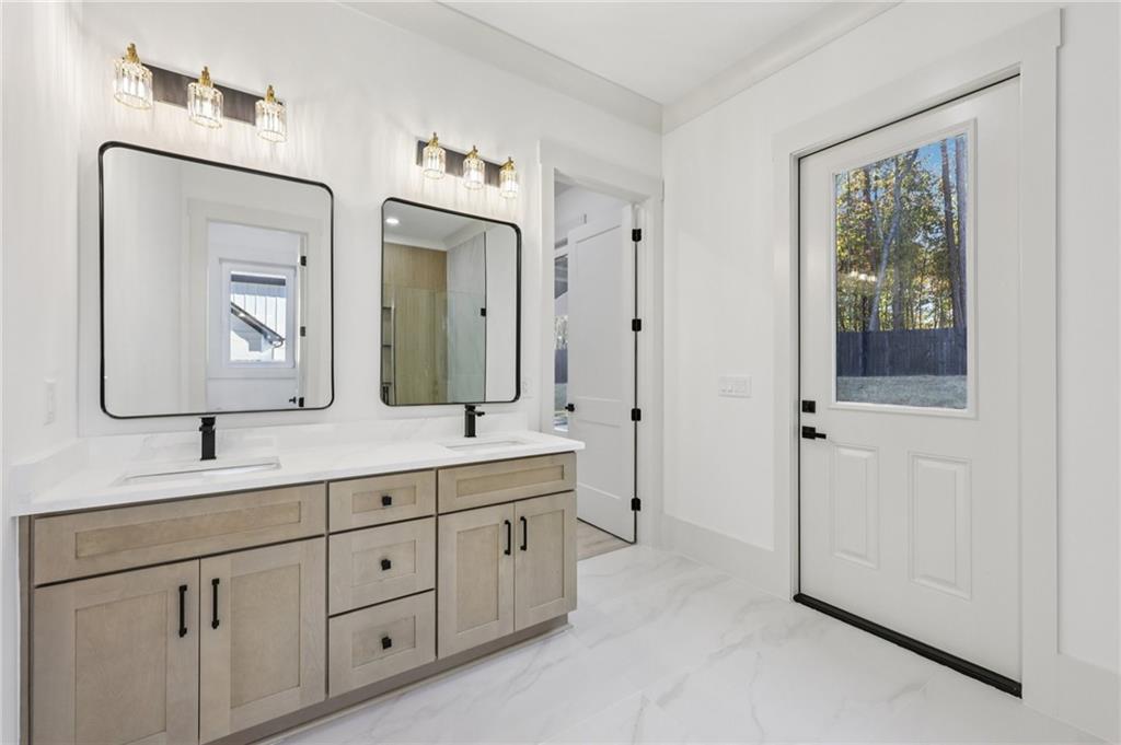 3209 Bold Springs Road Dacula, GA 30019 - Photo 30 of 62 a bathroom with a double vanity sink and a mirror