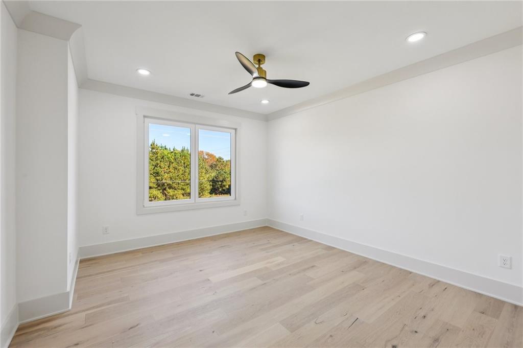 3209 Bold Springs Road Dacula, GA 30019 - Photo 35 of 62 an empty room with wooden floor and windows