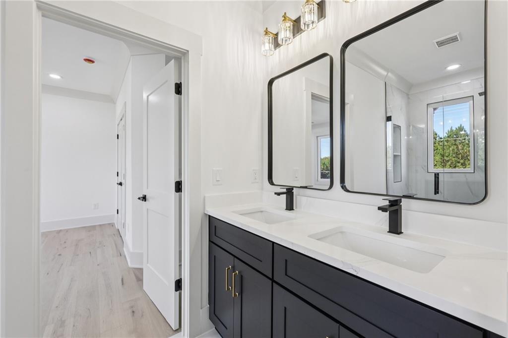3209 Bold Springs Road Dacula, GA 30019 - Photo 39 of 62 a bathroom with double vanity sink a mirror and shower