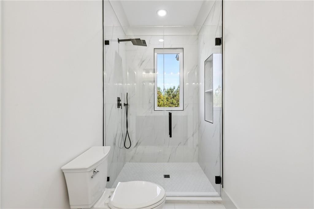 3209 Bold Springs Road Dacula, GA 30019 - Photo 40 of 62 a bathroom with a shower and a toilet