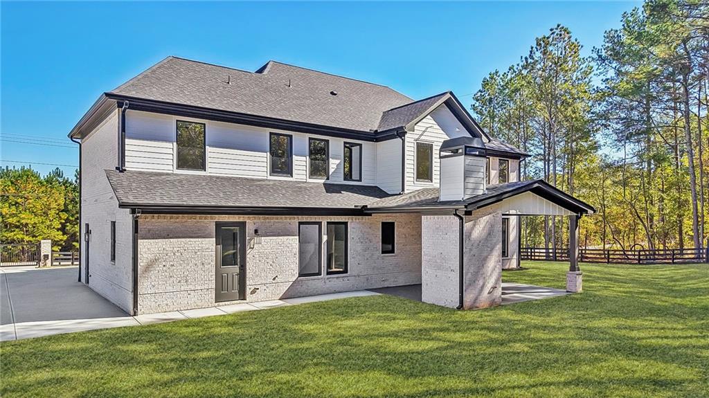 3209 Bold Springs Road Dacula, GA 30019 - Photo 60 of 62 a front view of a house with a yard and garage
