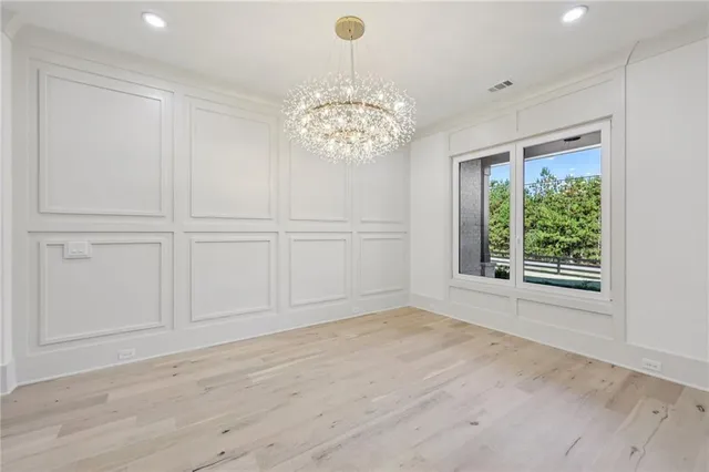 a large white kitchen with a sink stainless steel appliances and cabinets