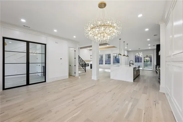 a large kitchen with stainless steel appliances granite countertop a stove and a large window with garden view