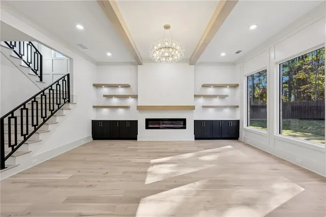 a large kitchen with stainless steel appliances kitchen island a large counter top and a wooden floors