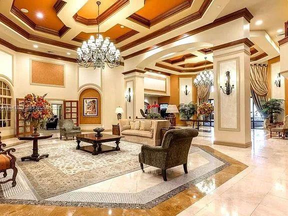 a living room with couch a dining table and a chandelier