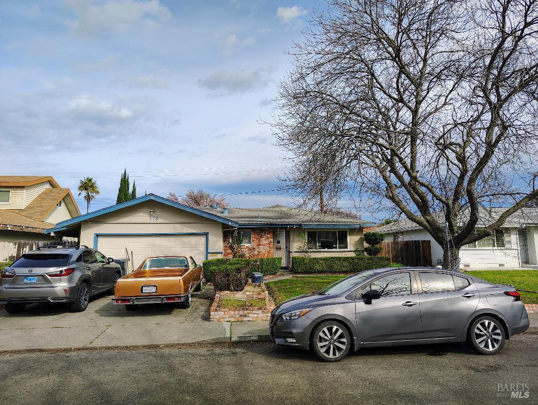 a front view of a house with parking space