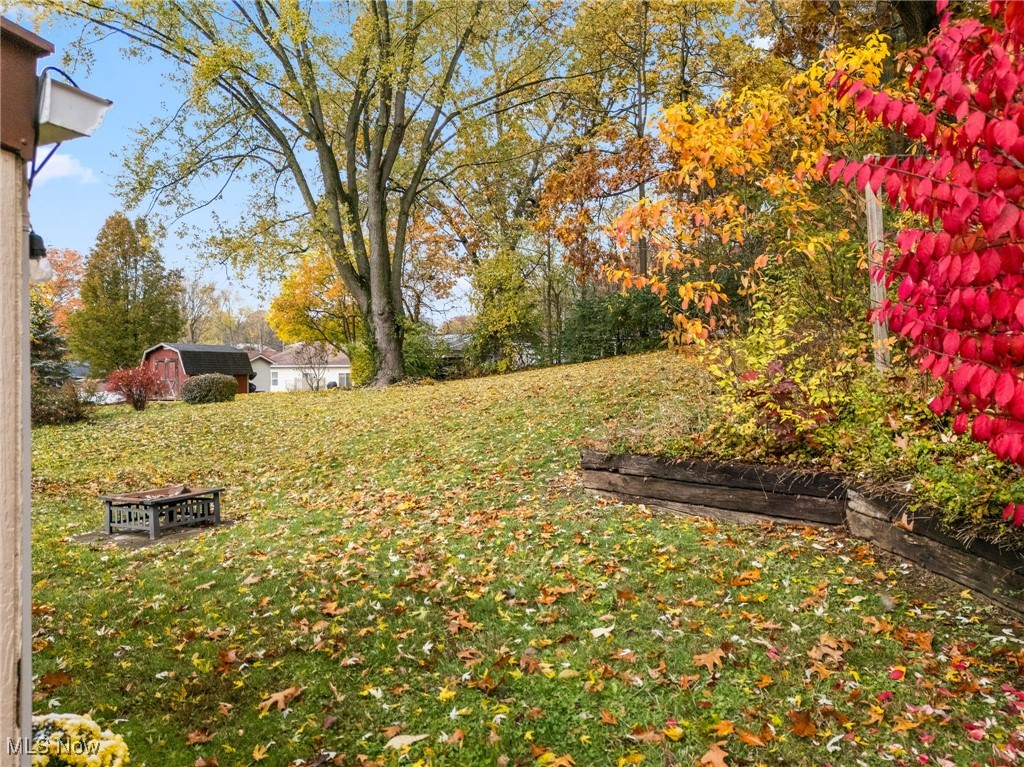 4727 15th Street Northwest Canton, OH 44708 - Photo 34 of 37 View of grassy yard with a fire pit and a storage unit