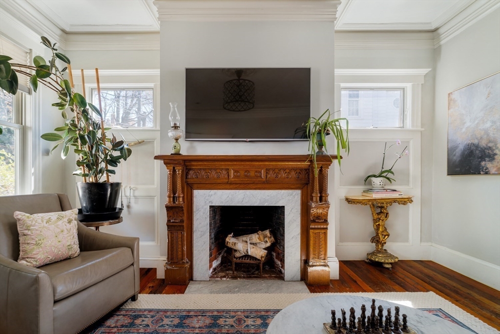 70 Oxford Street Somerville, MA 02143 - Photo 15 of 38 a living room with furniture a flat screen tv and a fireplace