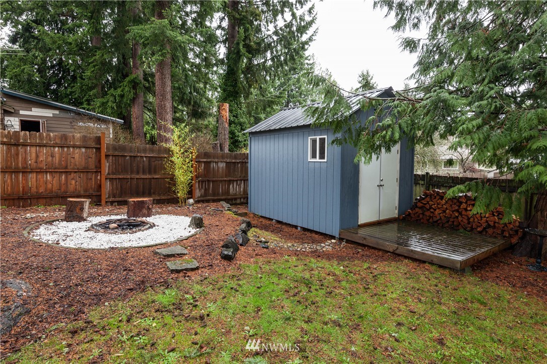 22415 73rd Place West Edmonds, WA 98026 - Photo 22 of 25 a backyard of a house with fountain table and chairs