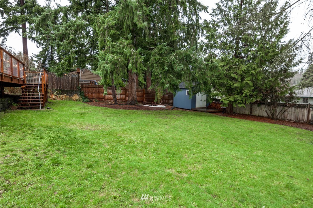 22415 73rd Place West Edmonds, WA 98026 - Photo 23 of 25 a view of a backyard with wooden fence and a bench