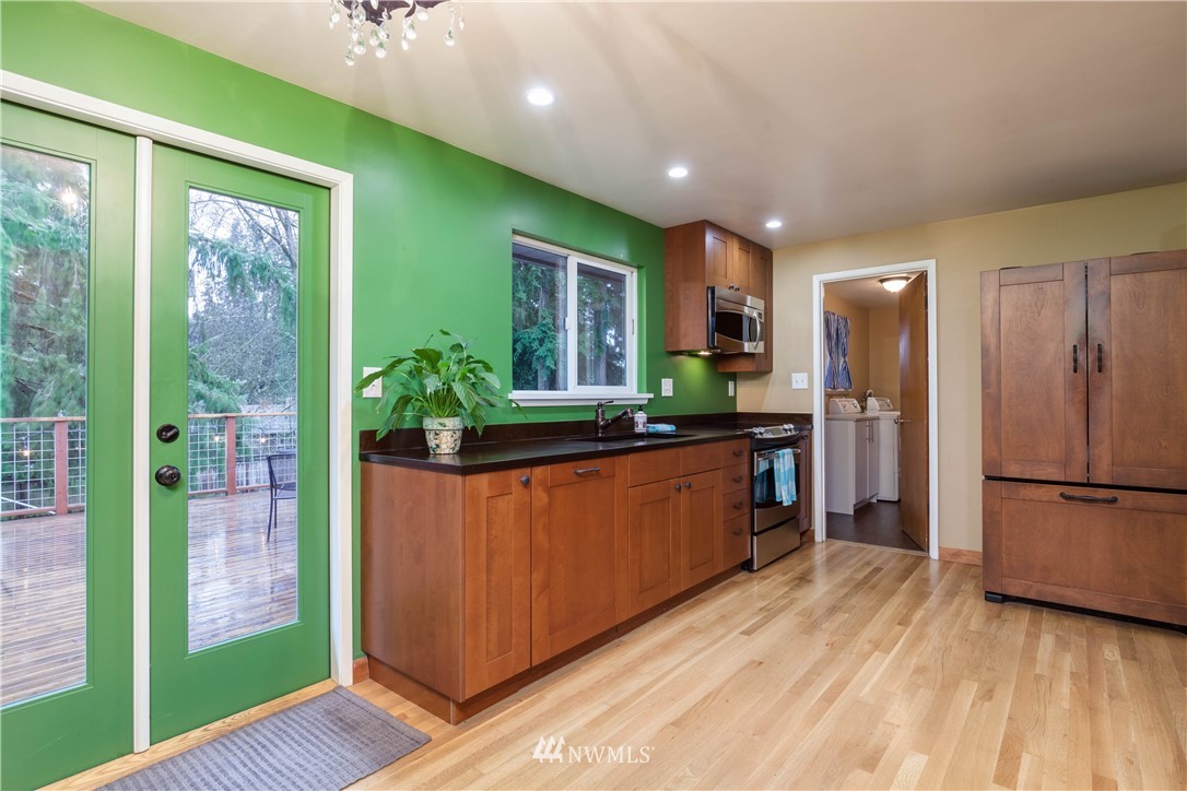 22415 73rd Place West Edmonds, WA 98026 - Photo 7 of 25 a kitchen with stainless steel appliances granite countertop a refrigerator a sink and a large window