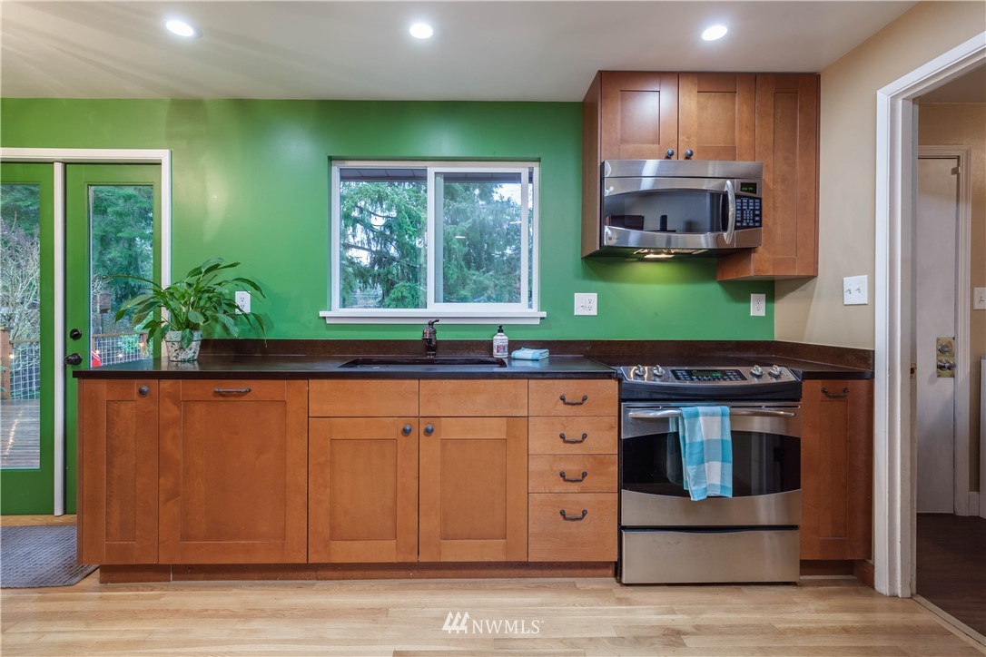 22415 73rd Place West Edmonds, WA 98026 - Photo 8 of 25 a kitchen with stainless steel appliances granite countertop a stove a sink and a microwave