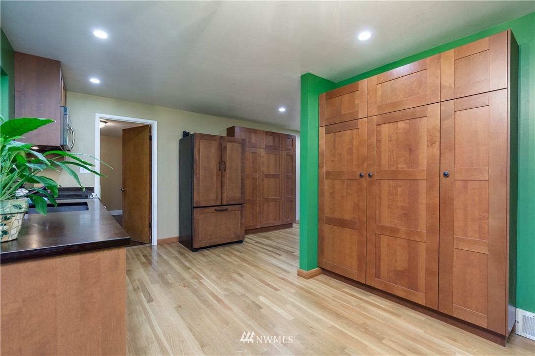 22415 73rd Place West Edmonds, WA 98026 - Photo 9 of 25 a view of an empty room with wooden floor and a kitchen