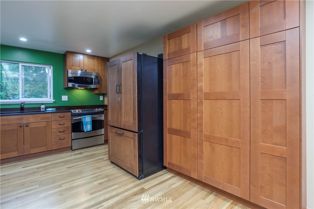 22415 73rd Place West Edmonds, WA 98026 - Photo 10 of 25 a kitchen with stainless steel appliances a refrigerator and a sink