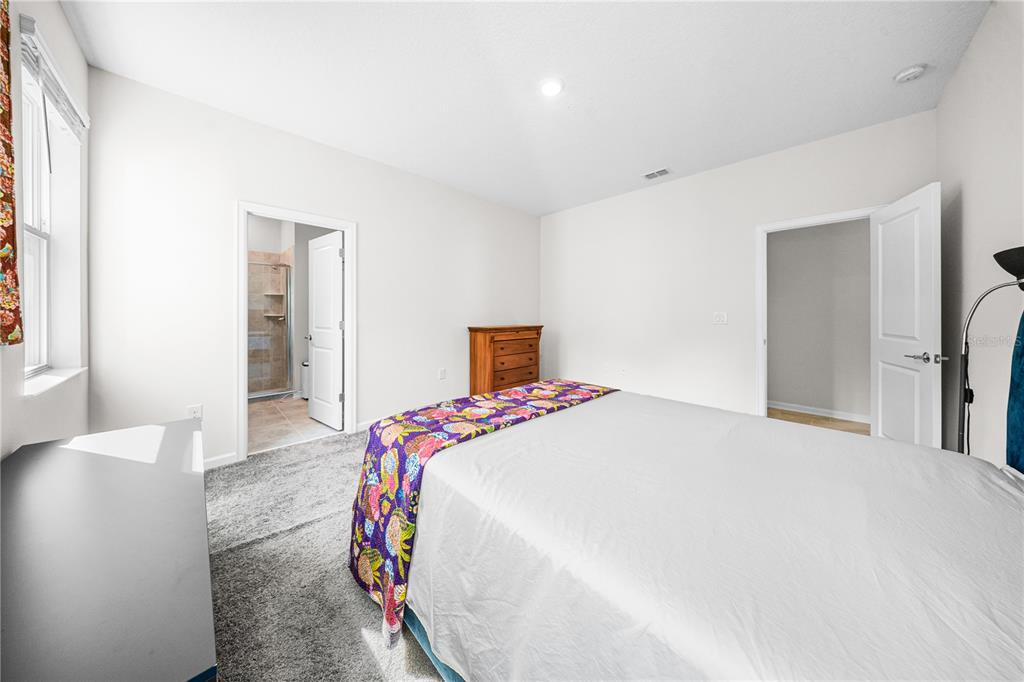 3388 Sagebrush Street Harmony, FL 34773 - Photo 27 of 56 a bedroom with a bed and a large mirror