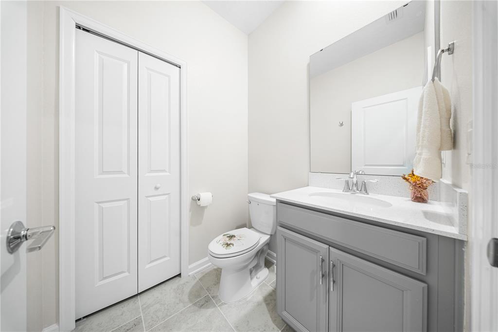 3388 Sagebrush Street Harmony, FL 34773 - Photo 33 of 56 a bathroom with a granite countertop sink vanity mirror and toilet