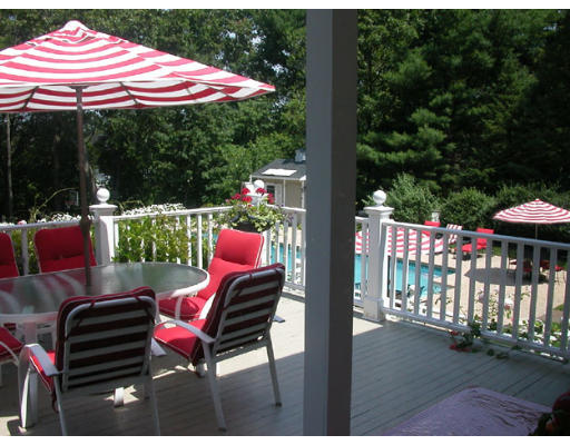 204 Chestnut Street Andover, MA 01810 - Photo 22 of 25 a patio with a table and chairs under an umbrella