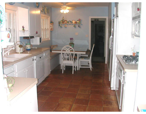204 Chestnut Street Andover, MA 01810 - Photo 4 of 25 a dining room with kitchen island granite countertop furniture a sink and a window