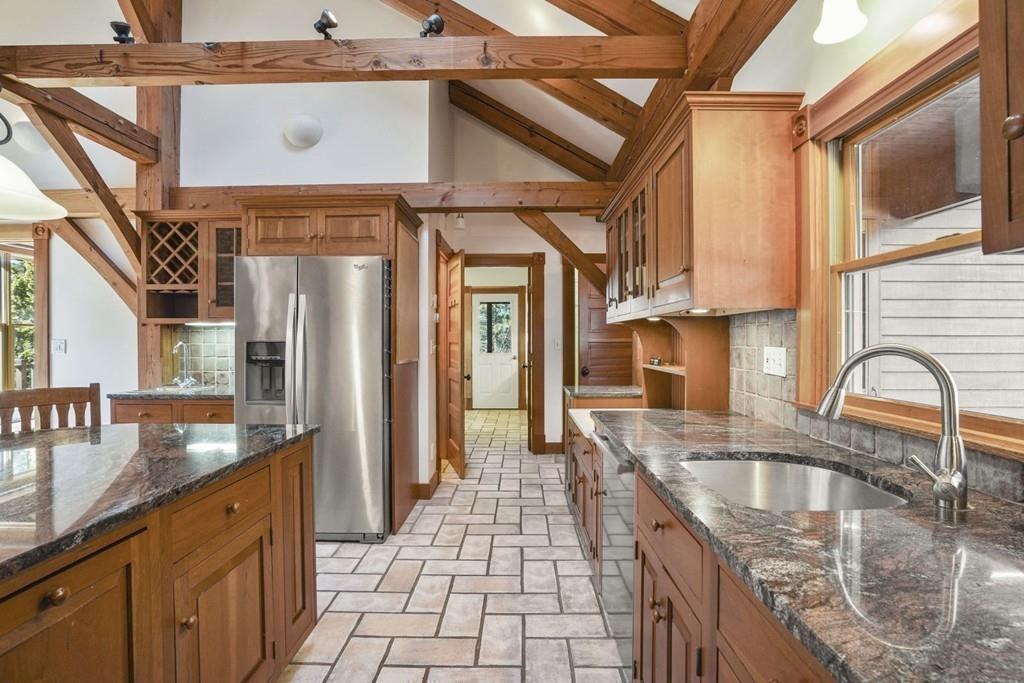 445 Conant Road Weston, MA 02493 - Photo 12 of 31 a kitchen with stainless steel appliances granite countertop a sink a stove and a refrigerator
