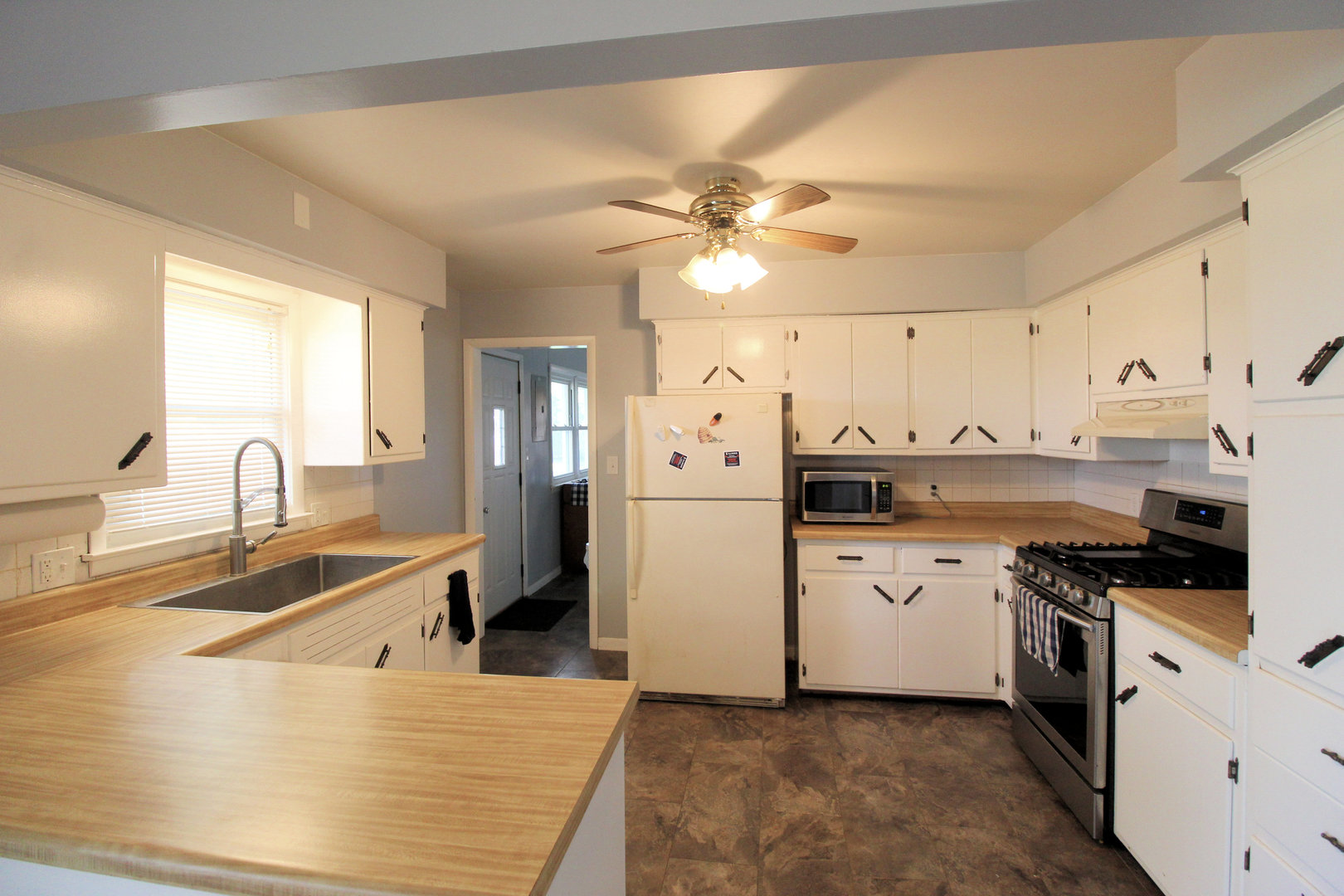2838 River Road Kankakee, IL 60901 - Photo 11 of 24 a kitchen with granite countertop a sink stainless steel appliances and cabinets