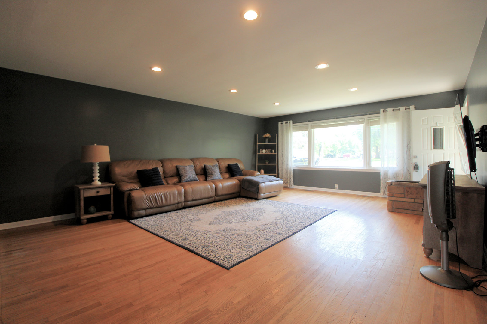 2838 River Road Kankakee, IL 60901 - Photo 2 of 24 a living room with furniture a flat screen tv and a window