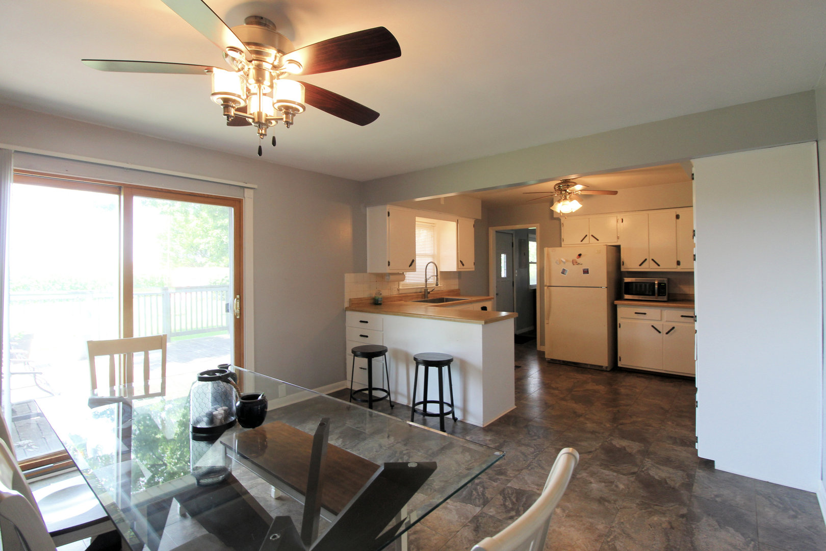 2838 River Road Kankakee, IL 60901 - Photo 8 of 24 a view of kitchen with sink refrigerator dining table and chairs