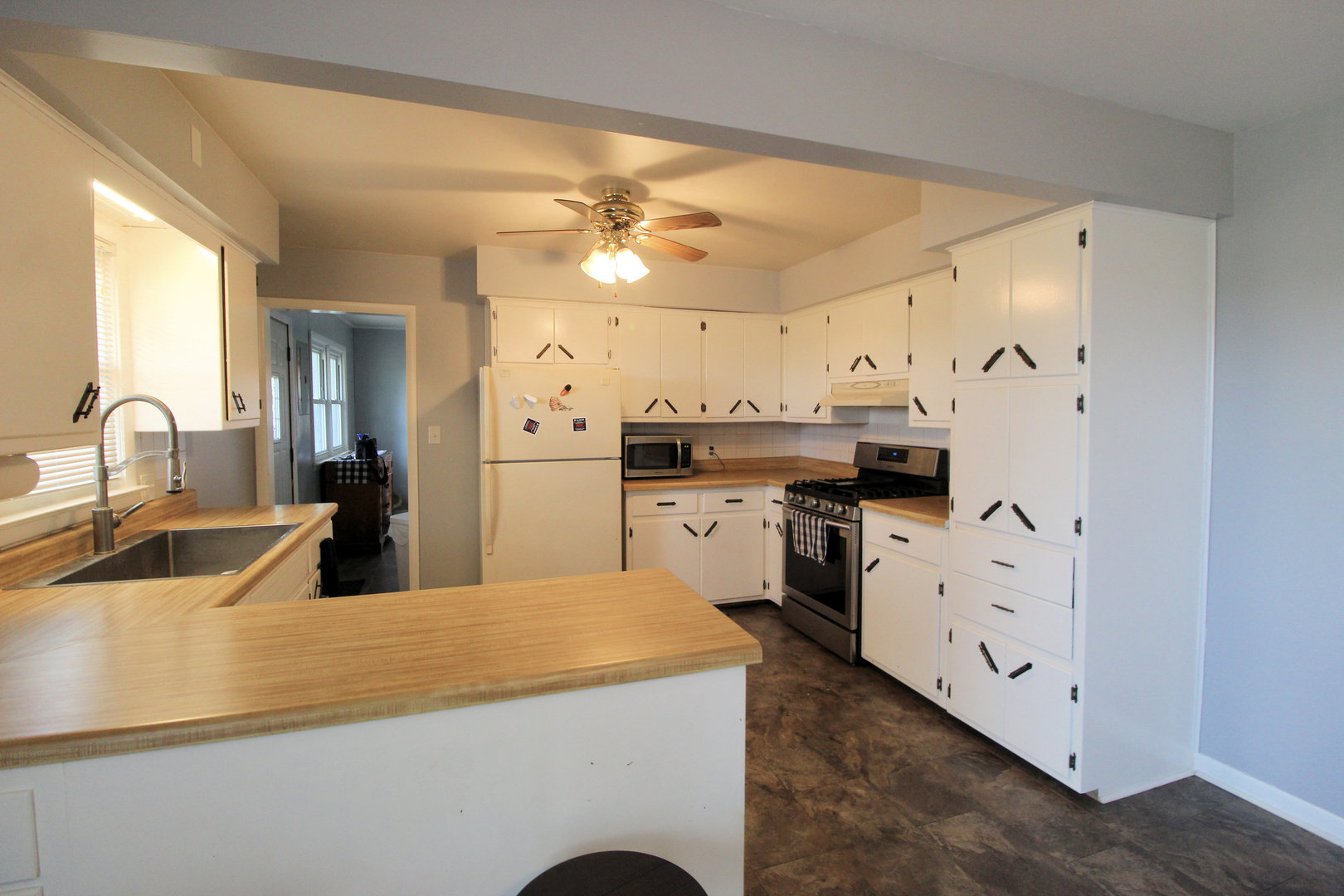 2838 River Road Kankakee, IL 60901 - Photo 10 of 24 a kitchen with granite countertop a sink and white cabinets